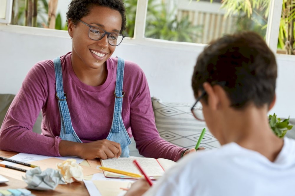 A teacher is explaining to the student during the lesson